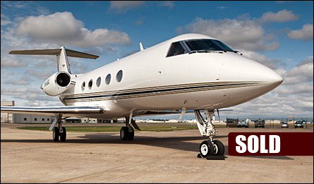 A white Gulfstream GIII G3 private jet is parked on an airport tarmac under a partly cloudy sky, with a "SOLD" sign in the lower right corner, highlighting this used aircraft's recent sale.