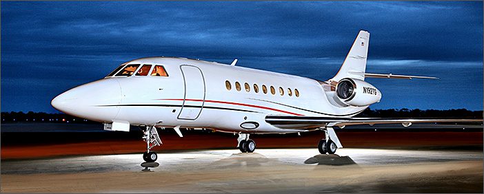 A white 1997 Dassault Falcon 2000 serial number 0035, a used corporate jet, sits on the runway.