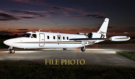 A white Westwind I for sale is parked on a runway at dusk under a partly cloudy sky. The words "FILE PHOTO" are overlaid on the image, showcasing this General Aviation Services Used Westwind jet.